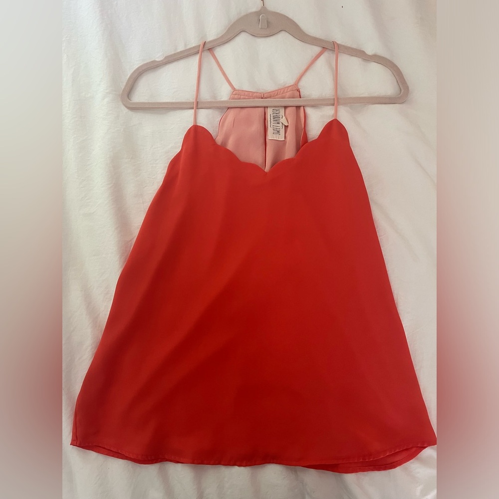 Scallop neck, reversible, sleeveless blouse.